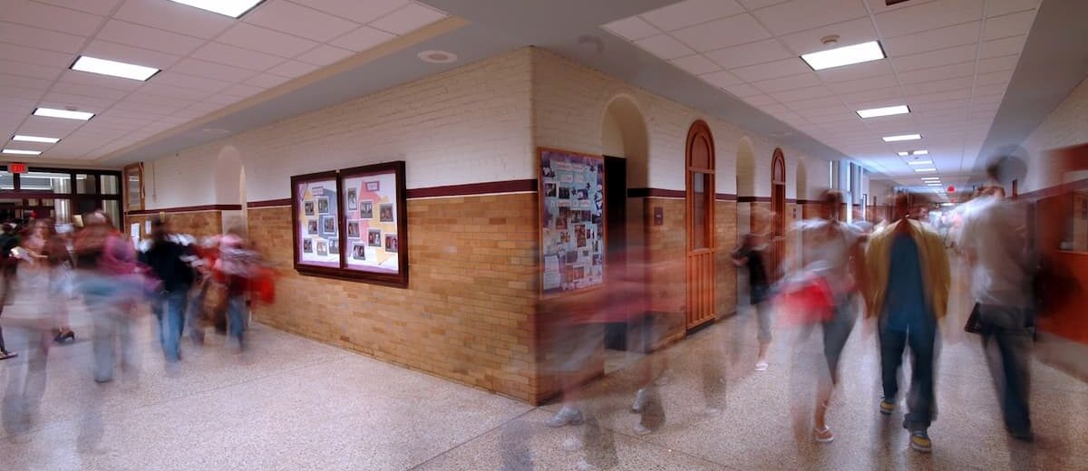 Picture of people moving through a school hallway, column by Curtis Lavarello